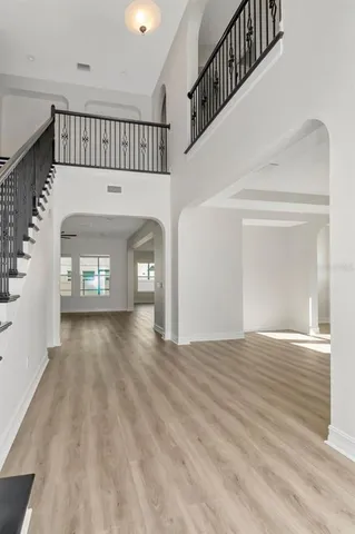 a view of entryway and hall with wooden floor