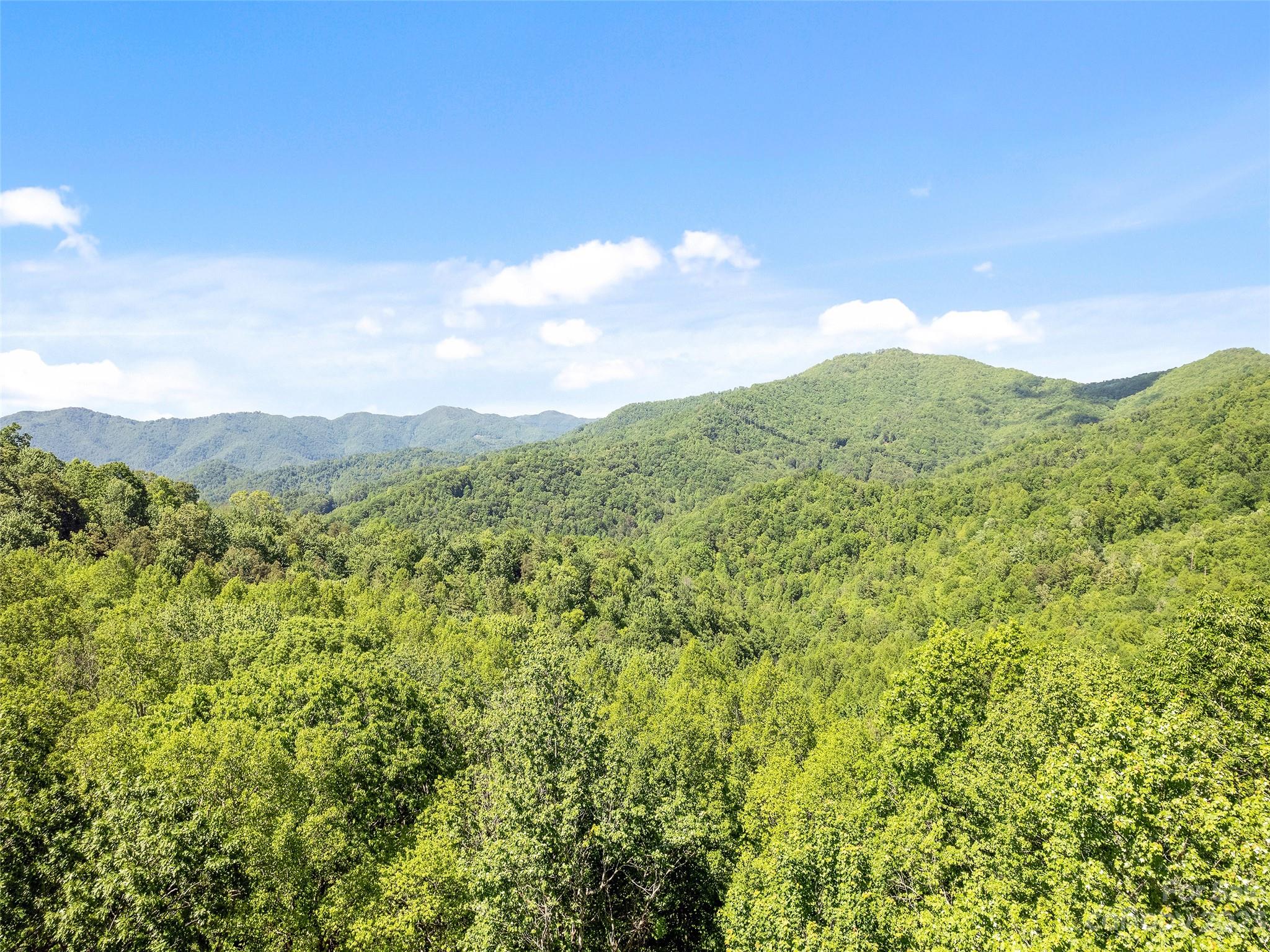 0 Walnut Ridge Drive, Unit 7 & 8 Clyde, NC 28721 - Photo 2 of 26 a view of a mountain range with lush green forest