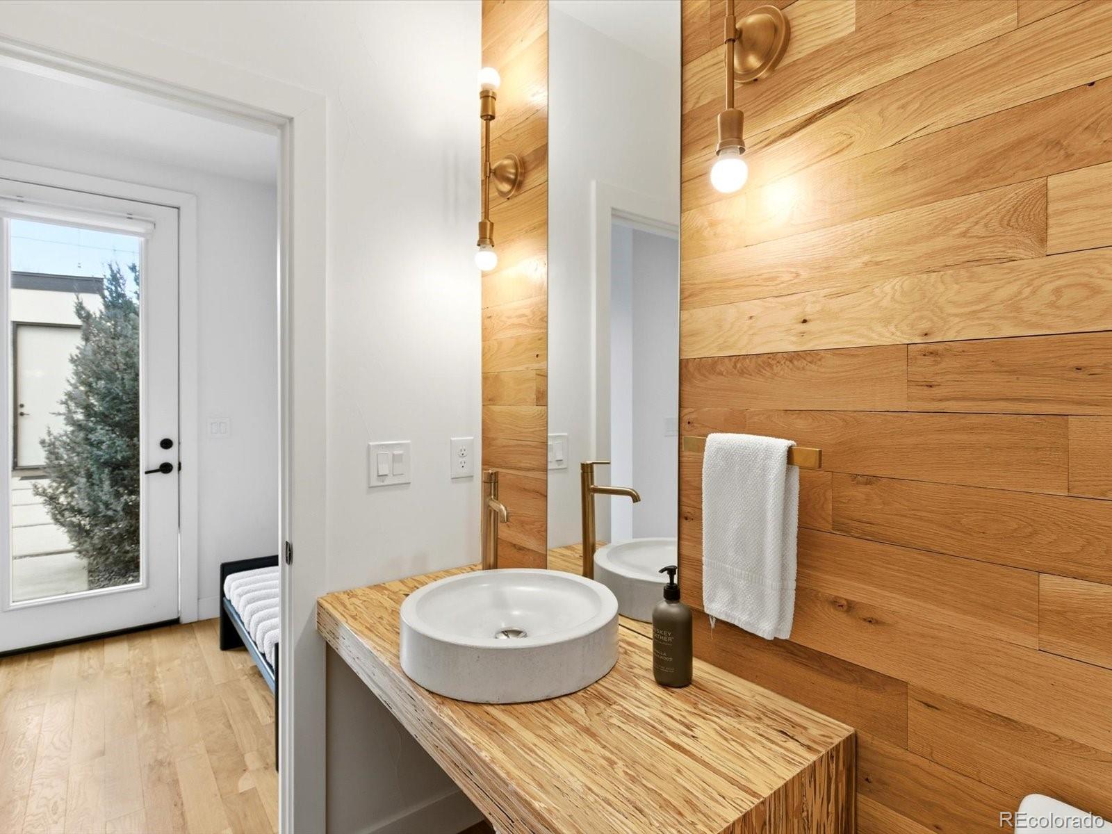 4141 Shoshone Street Denver, CO 80211 - Photo 17 of 50 a bathroom with a granite countertop sink and a mirror
