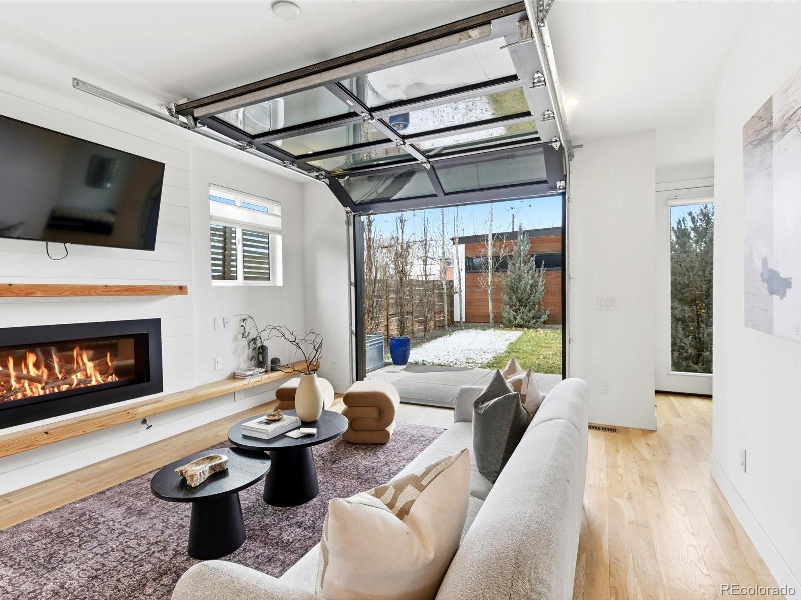 4141 Shoshone Street Denver, CO 80211 - Photo 18 of 50 a living room with furniture a flat screen tv and a fireplace