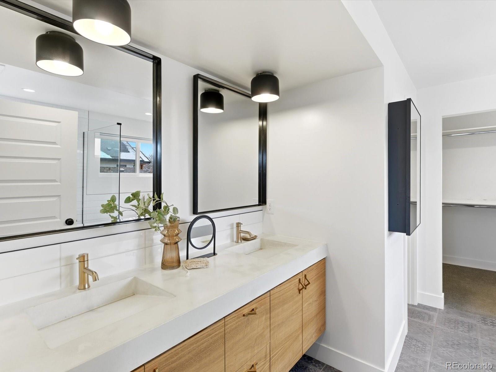 4141 Shoshone Street Denver, CO 80211 - Photo 24 of 50 a bathroom with a sink and a mirror