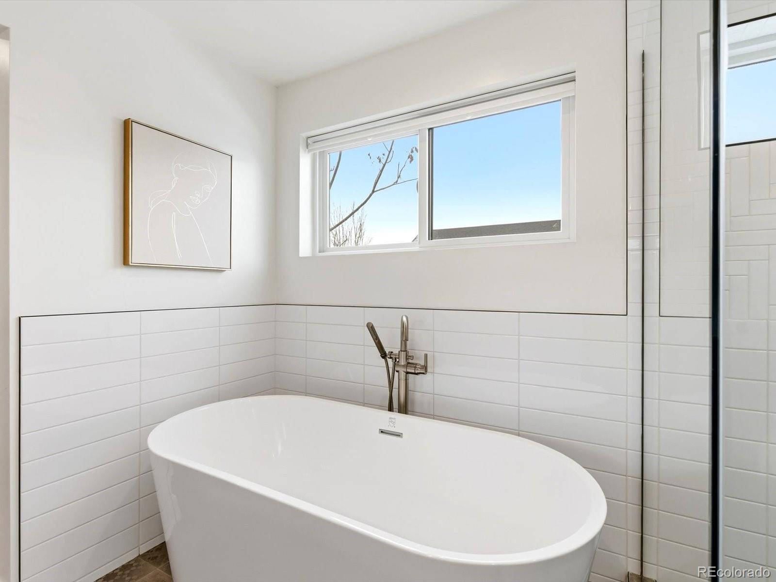 4141 Shoshone Street Denver, CO 80211 - Photo 26 of 50 a white bath tub sitting in a bathroom
