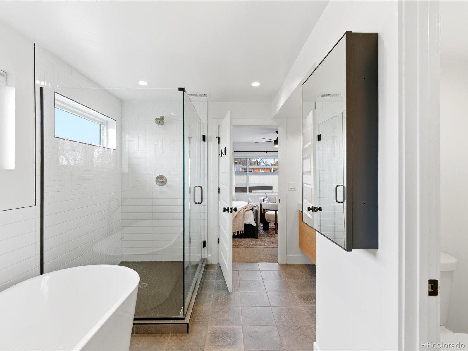 4141 Shoshone Street Denver, CO 80211 - Photo 28 of 50 a bathroom with a tub and a shower