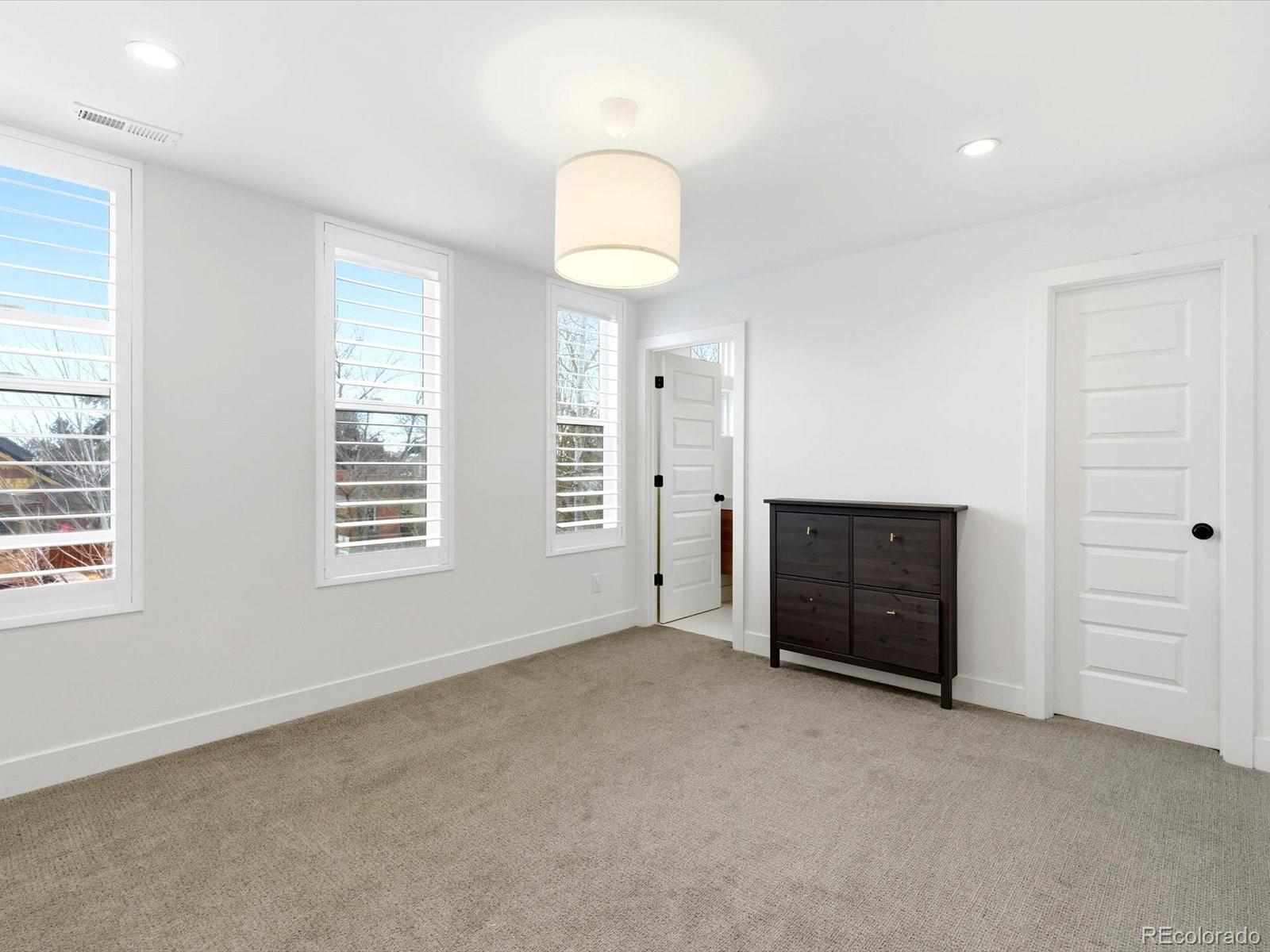 4141 Shoshone Street Denver, CO 80211 - Photo 33 of 50 an empty room with windows and cabinet