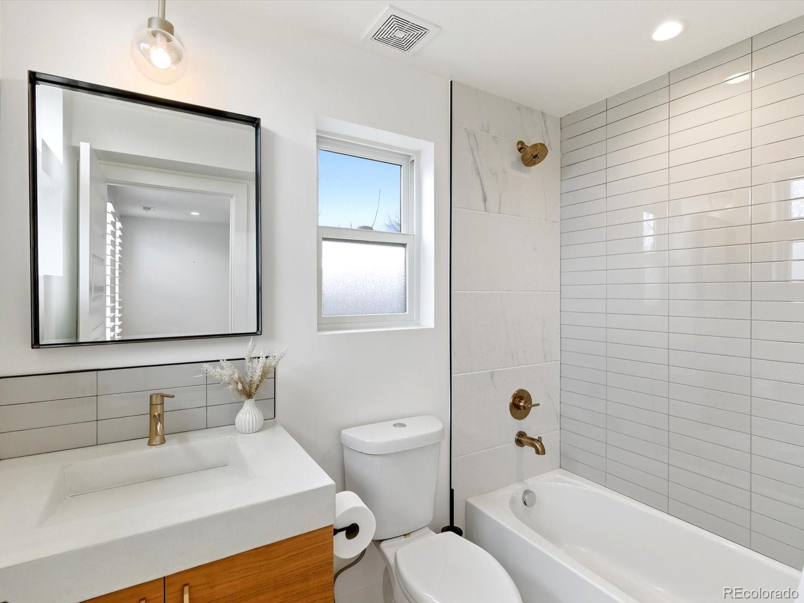 4141 Shoshone Street Denver, CO 80211 - Photo 34 of 50 a bathroom with a sink a toilet and shower