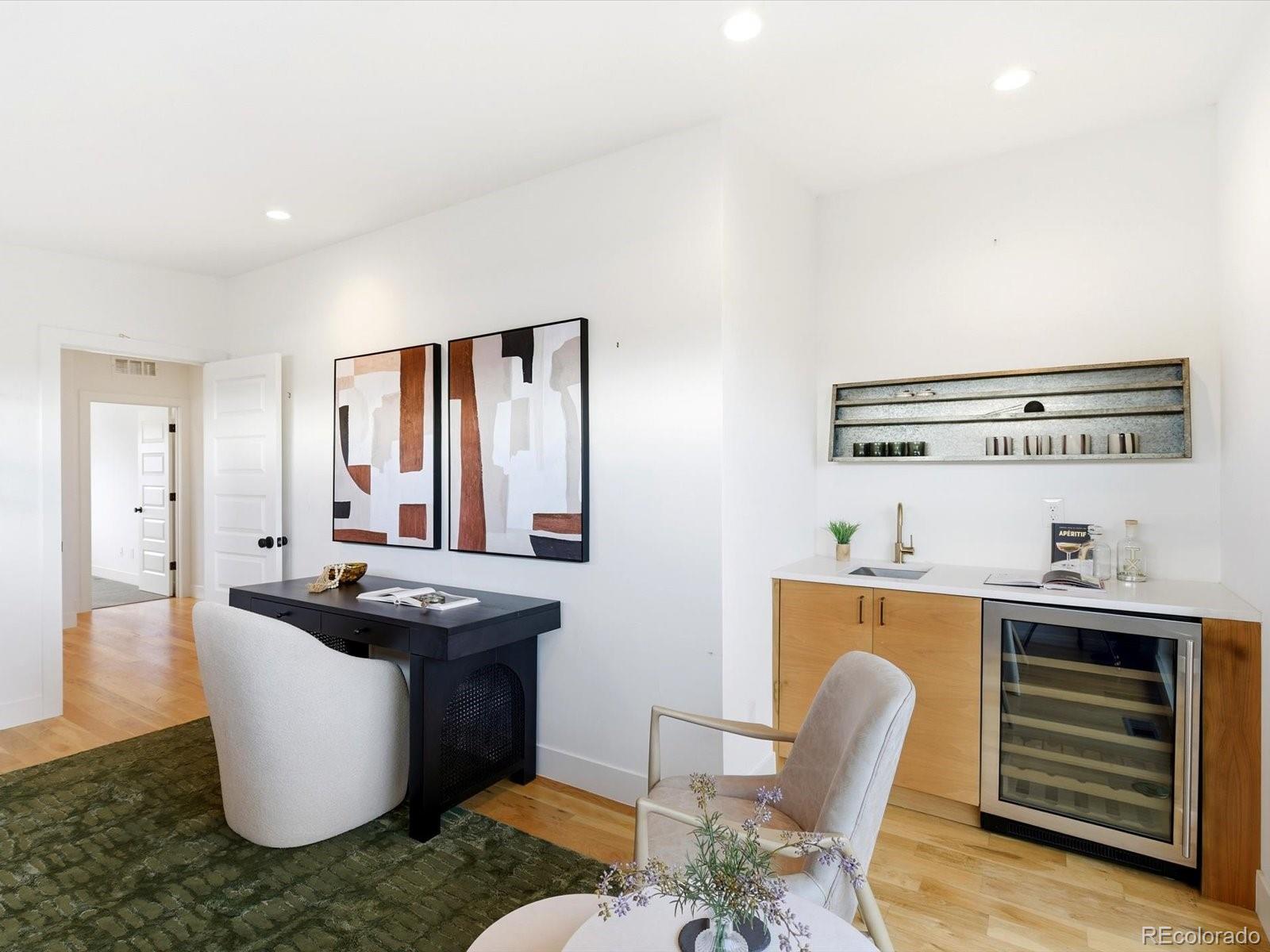 4141 Shoshone Street Denver, CO 80211 - Photo 39 of 50 a room with kitchen island stainless steel appliances a dining table and chairs