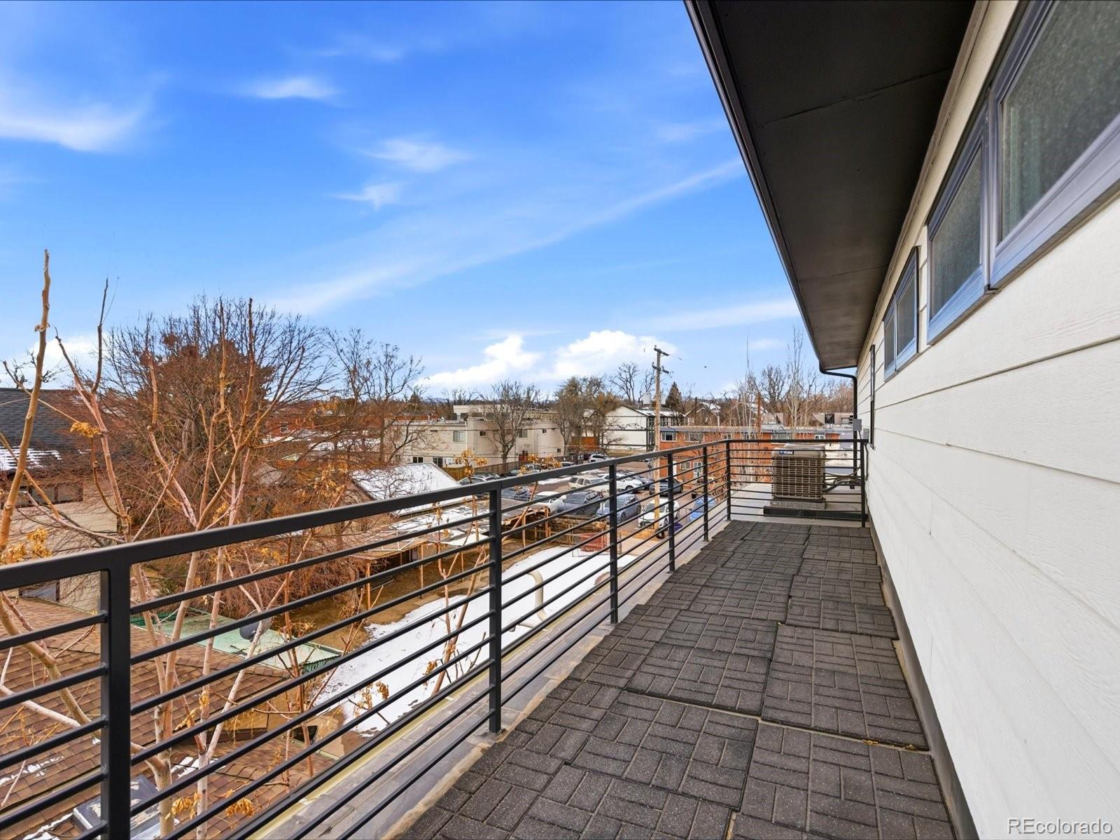 4141 Shoshone Street Denver, CO 80211 - Photo 43 of 50 a view of a balcony with wooden floor and city view