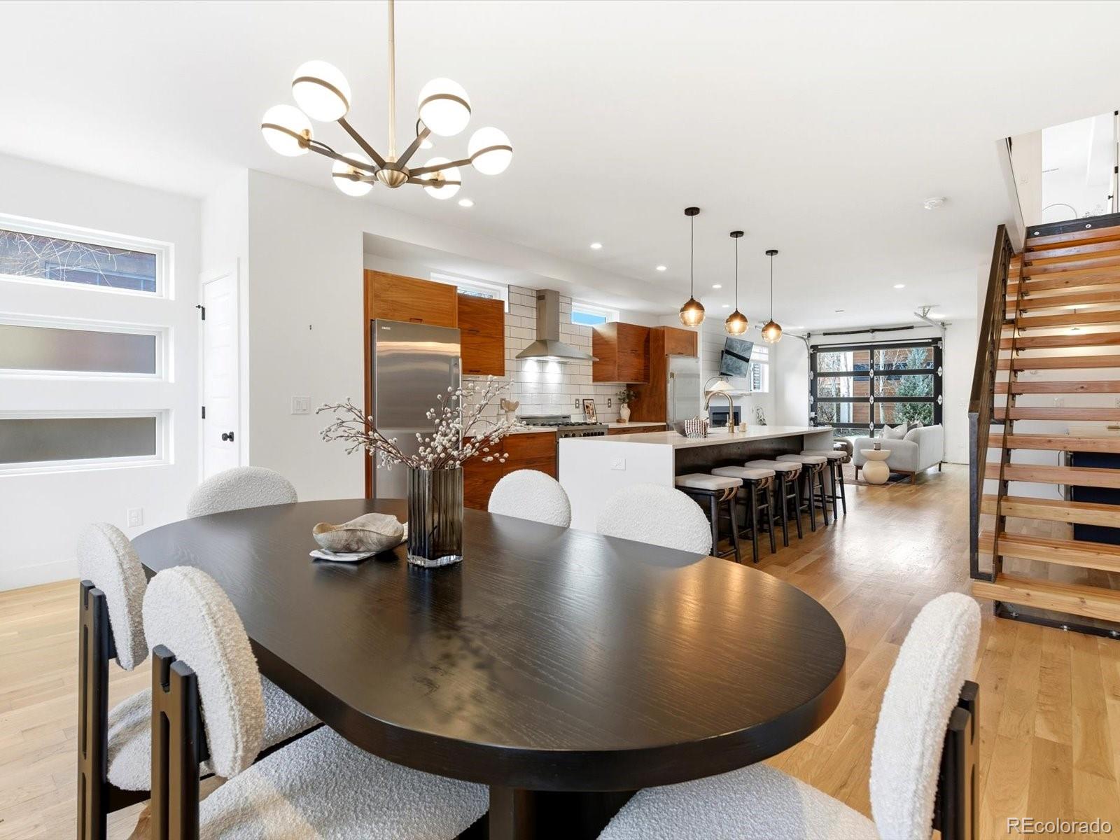 4141 Shoshone Street Denver, CO 80211 - Photo 8 of 50 a dining room with furniture a rug and a chandelier