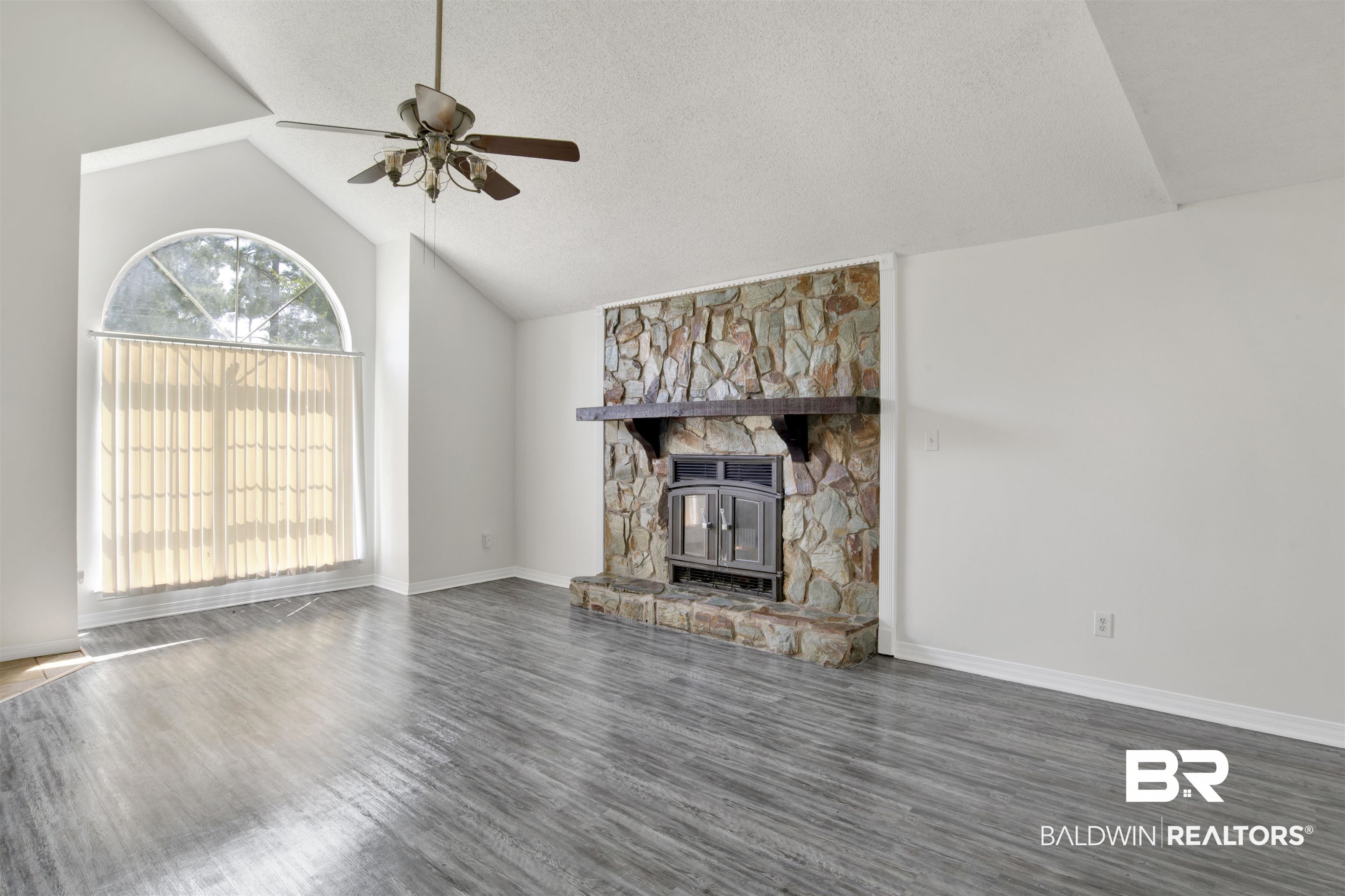5480 Country Club Boulevard Theodore, AL 36582 - Photo 8 of 36 Unfurnished living room with a fireplace, high vaulted ceiling, a textured ceiling, ceiling fan, and dark hardwood / wood-style floors