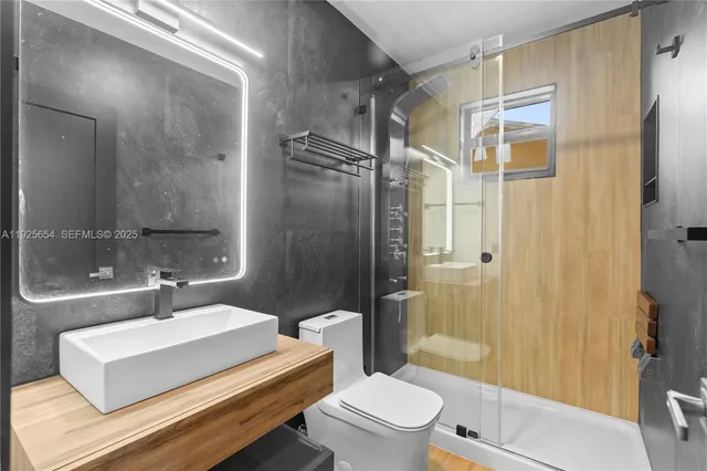 a bathroom with a sink toilet and shower