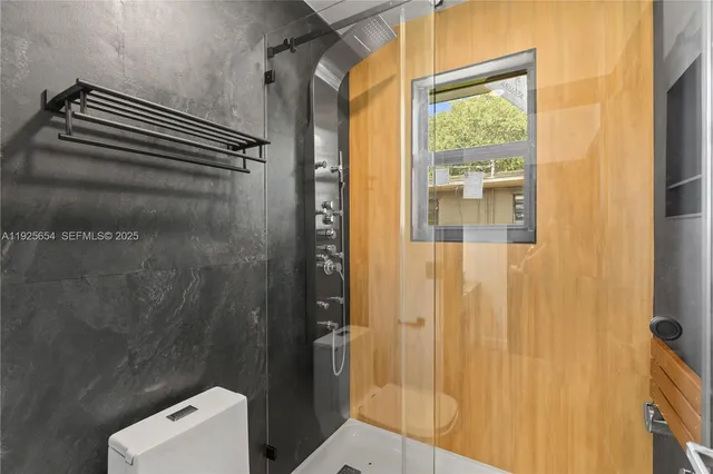 a bathroom with a shower and a sink