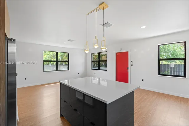 a kitchen with a sink a counter space and a window