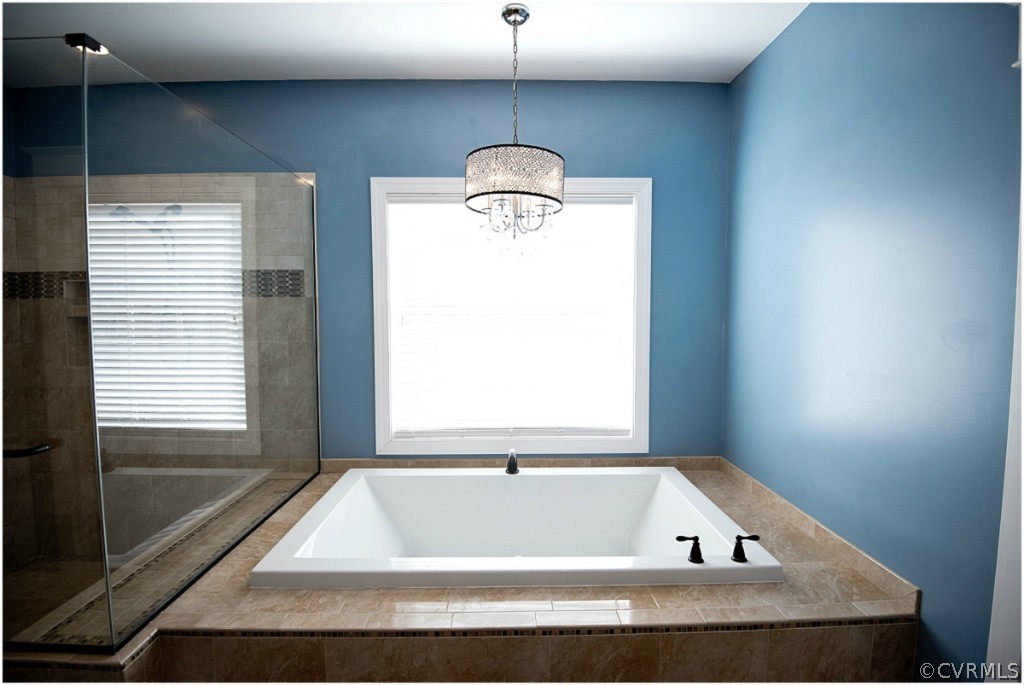 3822 Baldwin Road Chester, VA 23831 - Photo 11 of 22 a bath tub sitting in a bathroom next to a window