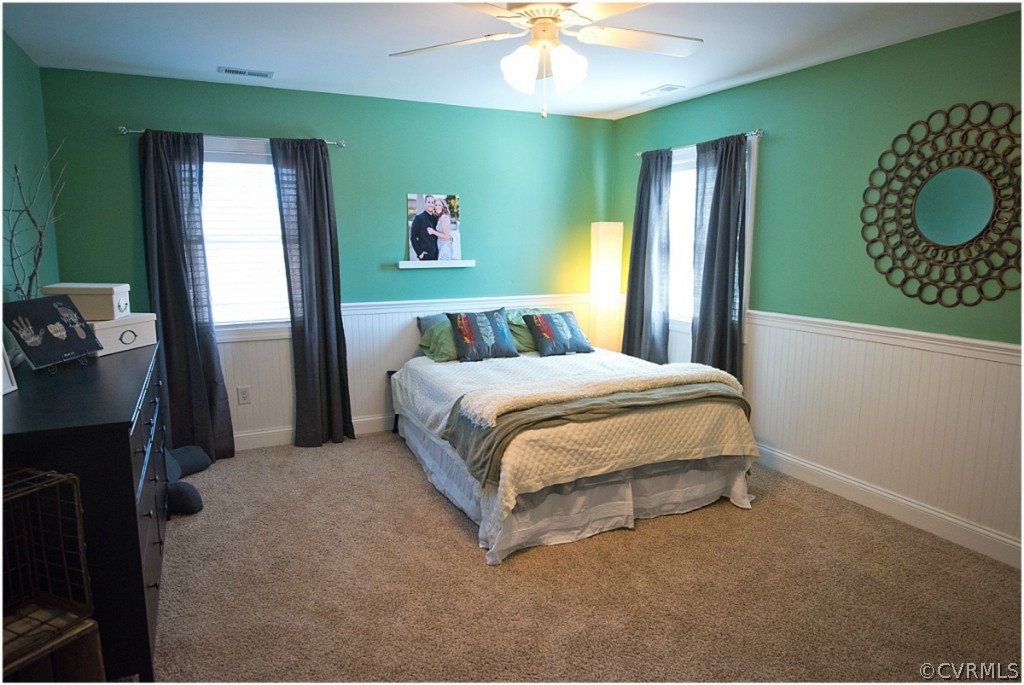 3822 Baldwin Road Chester, VA 23831 - Photo 15 of 22 a bedroom with a bed and a chandelier