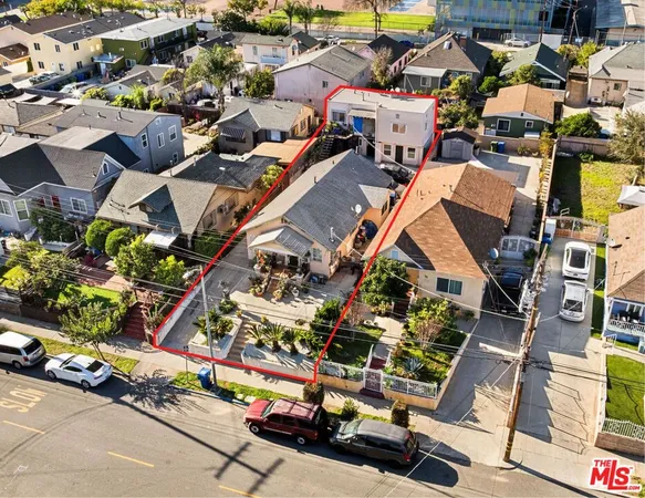 an aerial view of multiple houses with street