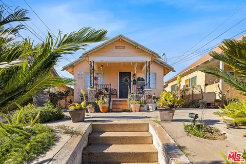 a view of a house with swimming pool and sitting area