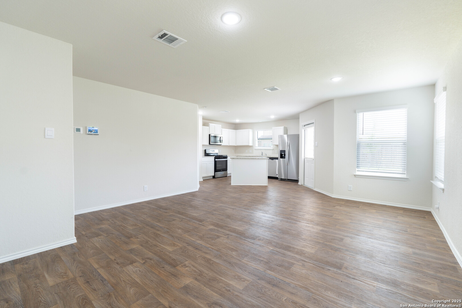 6806 Rondo Measure San Antonio, TX 78252 - Photo 12 of 25 a view of empty room with wooden floor