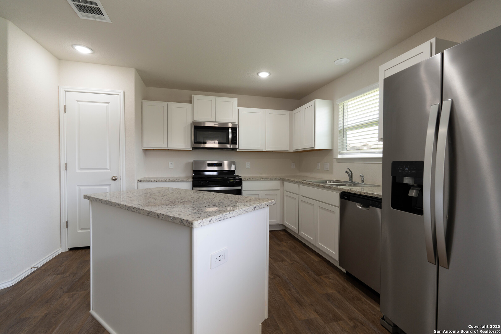 6806 Rondo Measure San Antonio, TX 78252 - Photo 13 of 25 a kitchen with stainless steel appliances granite countertop a refrigerator a stove a sink and a microwave