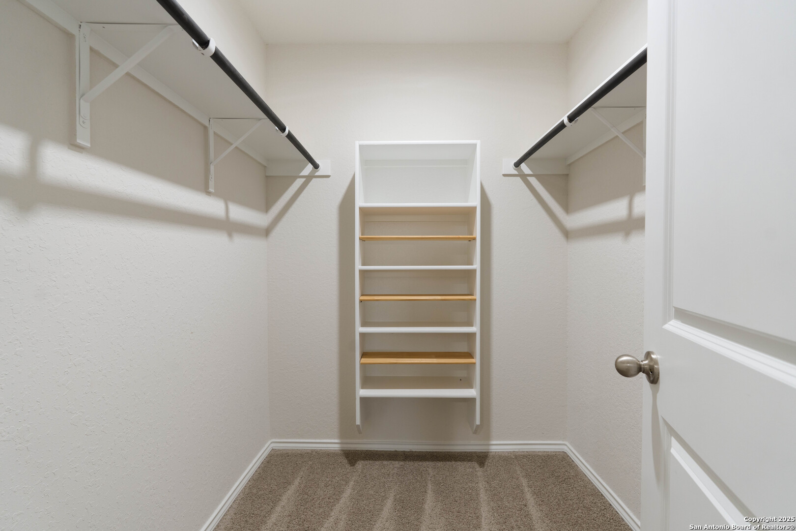 6806 Rondo Measure San Antonio, TX 78252 - Photo 17 of 25 a view of walk in closet with empty racks
