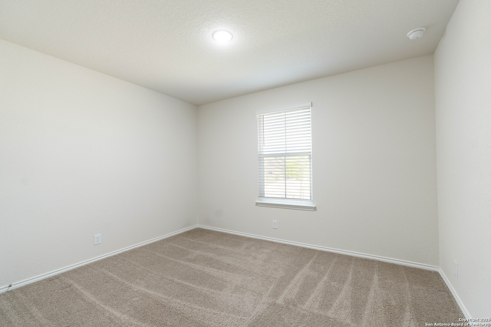 6806 Rondo Measure San Antonio, TX 78252 - Photo 19 of 25 an empty room with a window