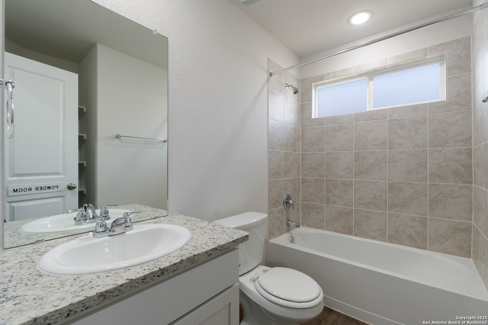 6806 Rondo Measure San Antonio, TX 78252 - Photo 20 of 25 a bathroom with a granite countertop toilet a sink and a bathtub