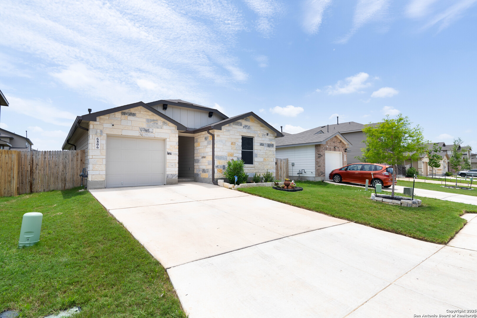 6806 Rondo Measure San Antonio, TX 78252 - Photo 3 of 25 a front view of a house with a yard and garage