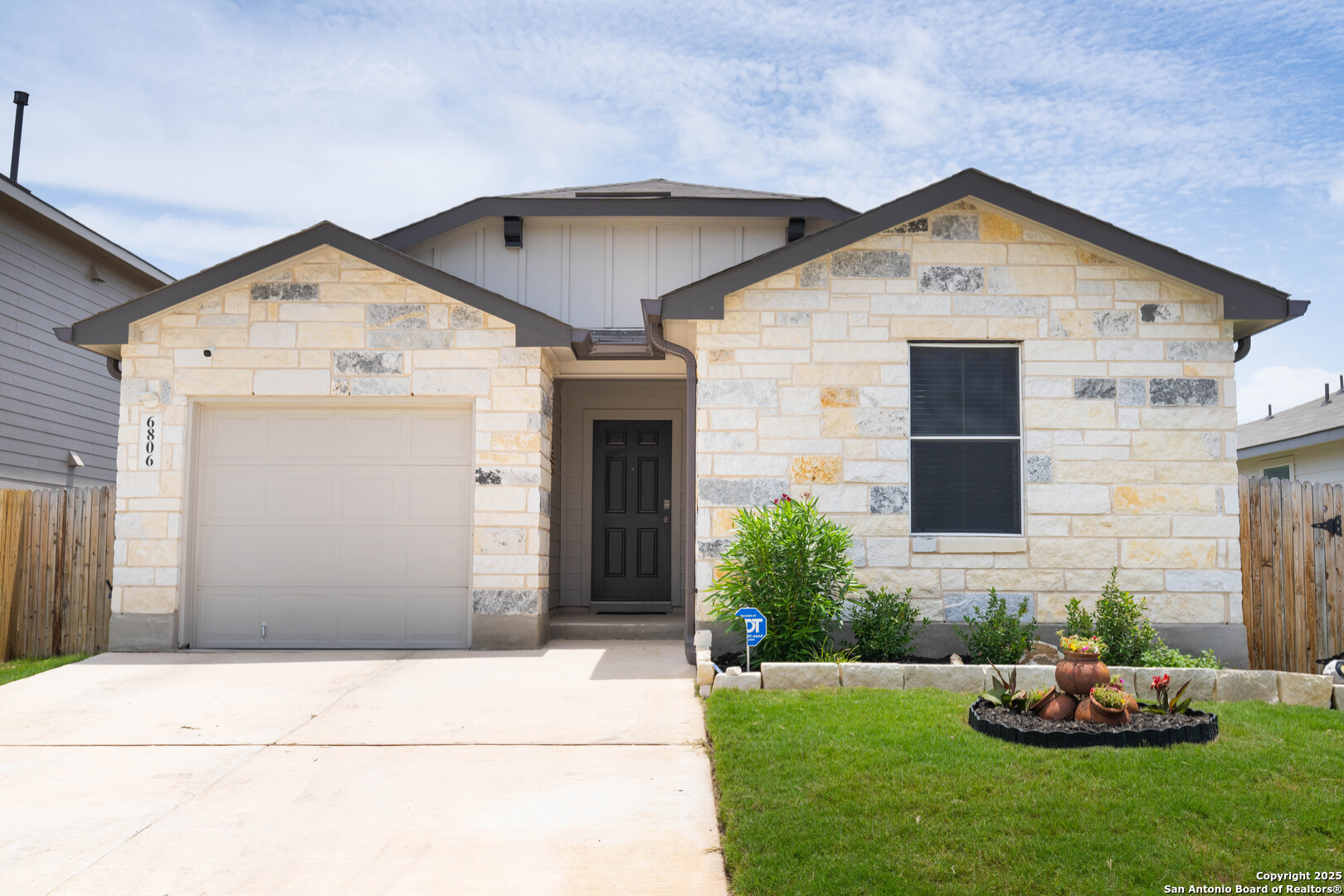 6806 Rondo Measure San Antonio, TX 78252 - Photo 4 of 25 a front view of a house with a yard and garage