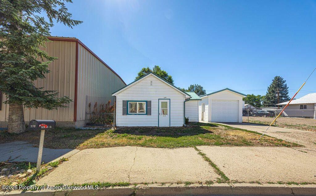 354 School Street Craig, CO 81625 - Photo 1 of 26 a view of a house with a yard and large tree