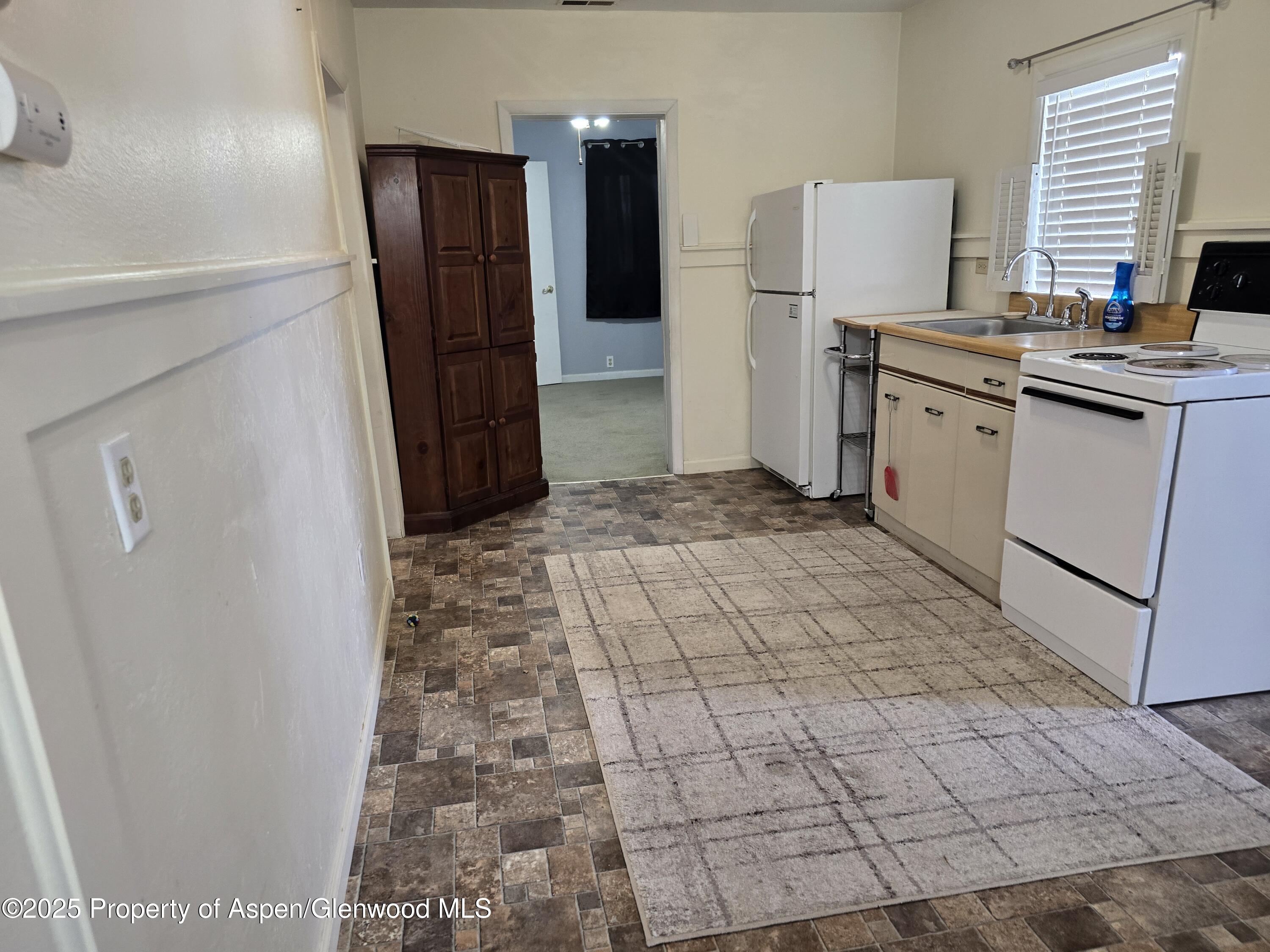 354 School Street Craig, CO 81625 - Photo 5 of 26 a room with a stove and a refrigerator