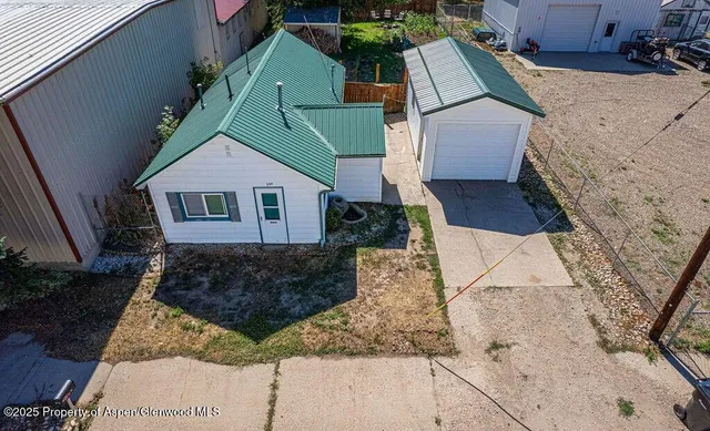 an aerial view of a house with a yard