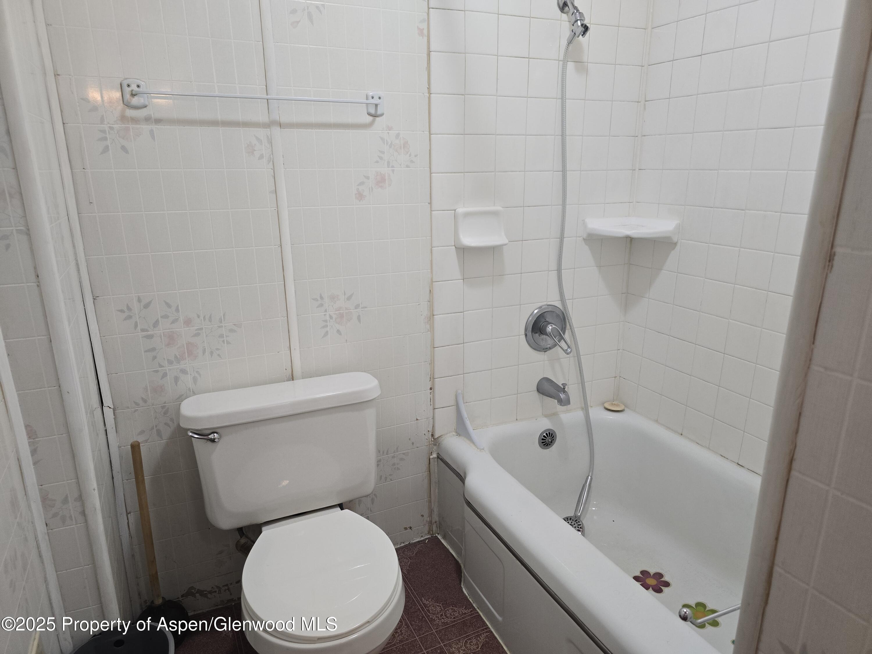 354 School Street Craig, CO 81625 - Photo 8 of 26 a white toilet sitting next to a bath tub