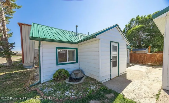 a kitchen with a refrigerator and a stove top oven