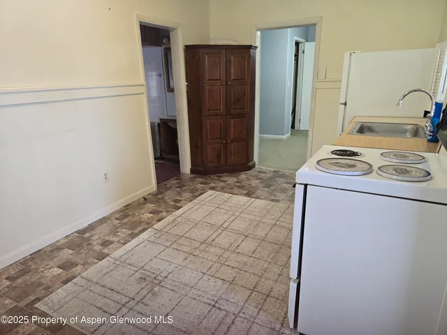 a room with a stove and a refrigerator