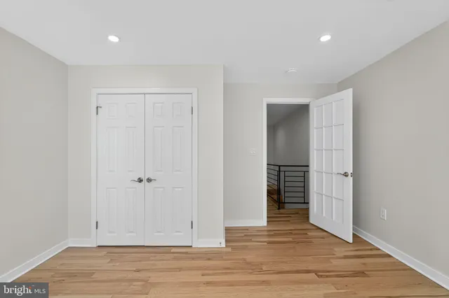 a view of an empty room with wooden floor