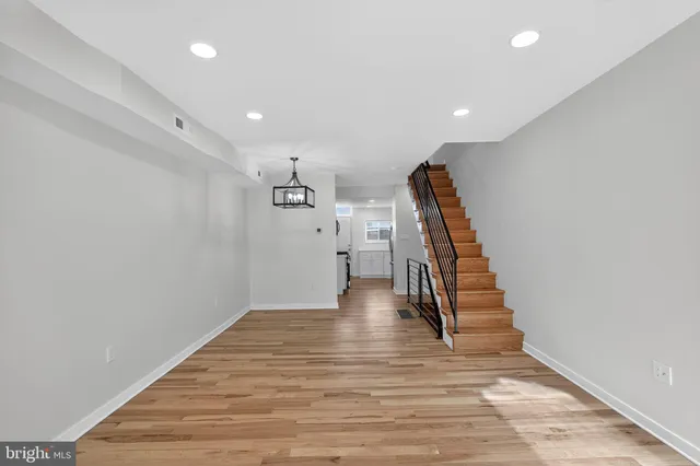 a view of entryway and hall with wooden floor