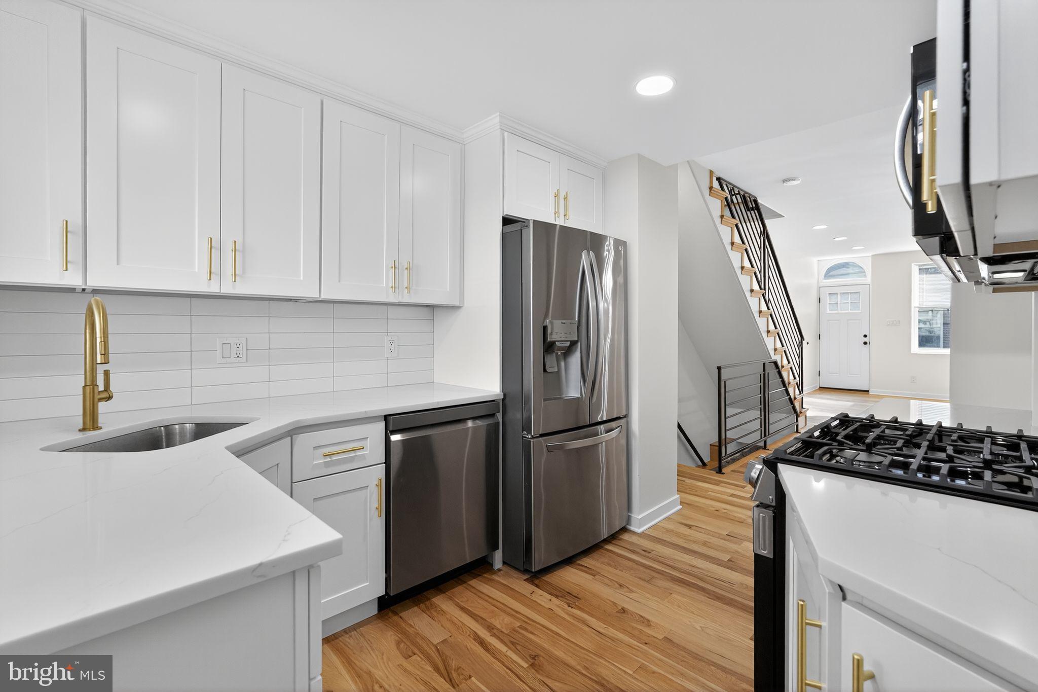 615 Sigel Street Philadelphia, PA 19148 - Photo 8 of 28 a kitchen with stainless steel appliances granite countertop a refrigerator and a stove top oven