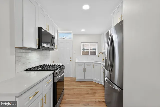 a kitchen with stainless steel appliances a refrigerator stove and microwave