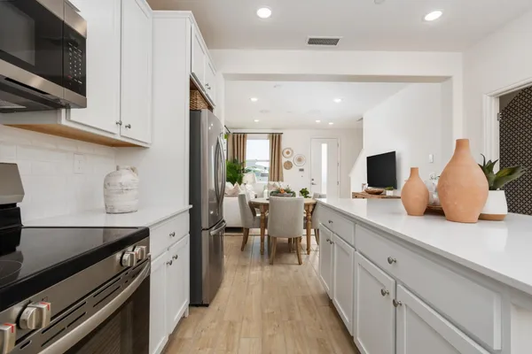 a kitchen with lots of counter space and stainless steel appliances
