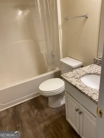 a white toilet sitting next to a bath tub