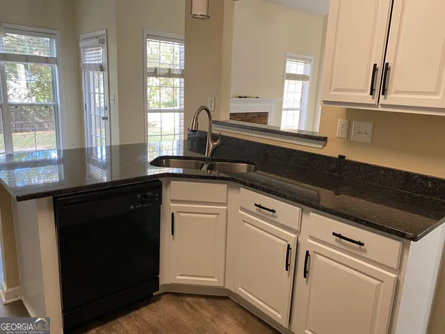 a close view of a kitchen sink and cabinets