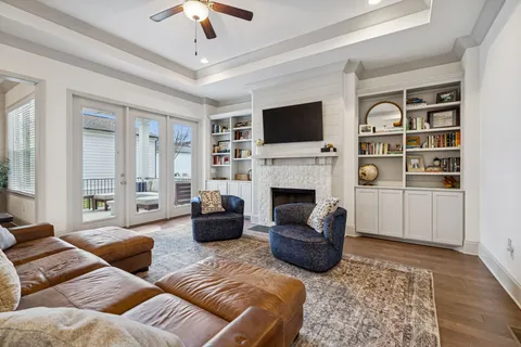 a kitchen with stainless steel appliances granite countertop a table chairs refrigerator and microwave