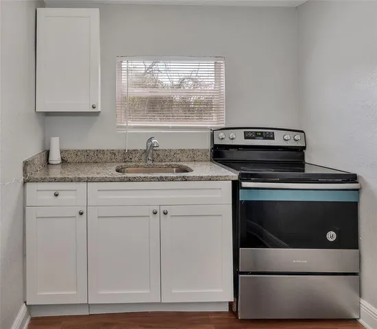 a stove top oven sitting inside of a kitchen