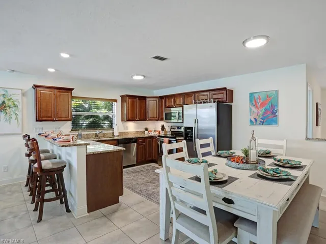 a kitchen with a table chairs and microwave