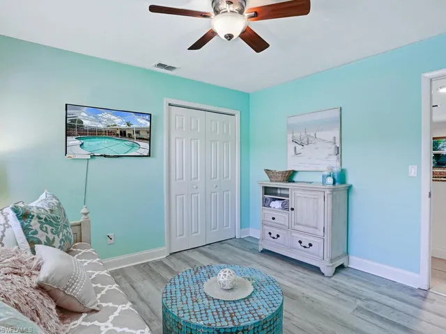 a bedroom with a bed and a painting on the wall