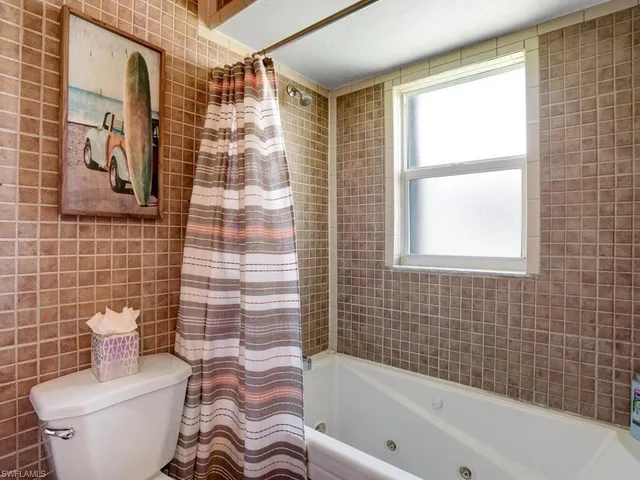 a bathroom with a toilet and a bathtub