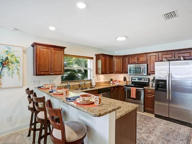 a kitchen that has a table and chairs in it