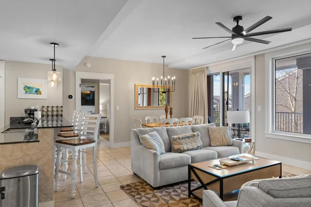 a living room with furniture and a chandelier