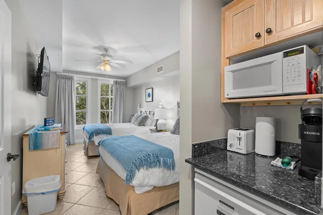 a bedroom with a bed and large windows