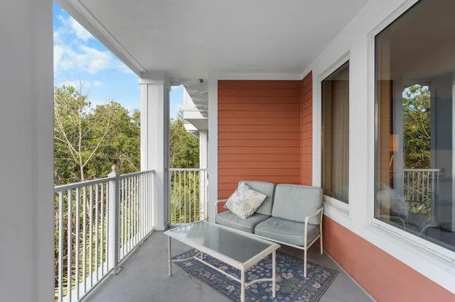 a balcony with furniture and a potted plant