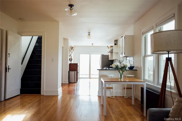 a kitchen with kitchen island wooden floor and refrigerator